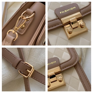 Detail of diamond quilted texture and golden twist lock on two-tone crossbody bag
