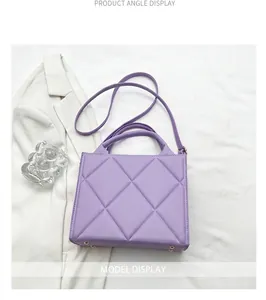 Detail showing the quilted diamond stitching and metal studs of the purple tote bag