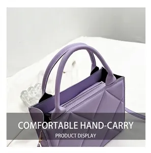 Detail of purple quilted tote bag showing sturdy dual handles and premium leather texture