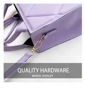 Detail of lavender PU tote bag featuring quilted diamond pattern and gold hardware hooks