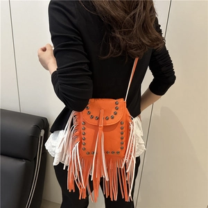 Retro fringed crossbody bag with rivets and orange color-blocking shown on a model