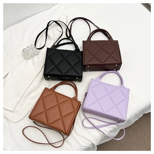 Detail view of four diamond-quilted handbags in purple, black, brown, and tan colors