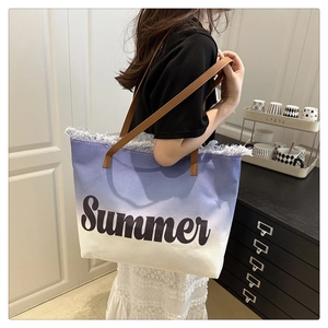 Detail of blue and white gradient canvas tote with Summer print and brown leather handles