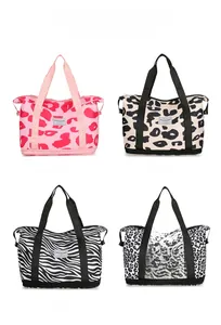Detailed close-up of travel bags in leopard and zebra prints with dual handles