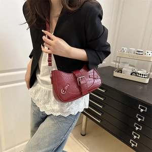 Deep red crocodile embossed underarm bag with punk rivets and adjustable buckles