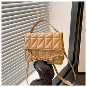 Detail of light khaki quilted crossbody bag featuring a thick chain handle and PU texture