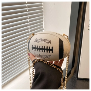 Detail of rugby-shaped white leather crossbody bag with chain and embroidery