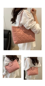 Detail of pink quilted tote bag featuring a metal bow charm and elegant chain strap