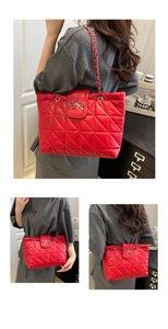 Detailed view of red quilted leather tote with silver bow clasp and chain strap