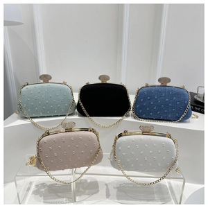 Macro detail of luxury evening clutch bags with chain straps and diamond buckles