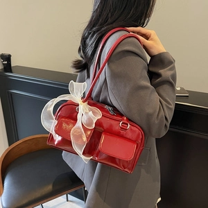 Red patent leather shoulder bag with white organza bow and double front pockets