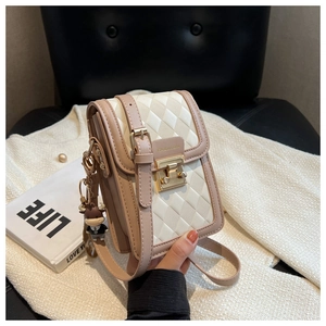 Close-up of diamond quilted shoulder bag with fashion lettering and cute charm