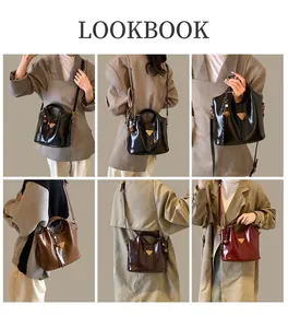 Close-up of gloss faux leather handbag details with triangle metal logo and tassel