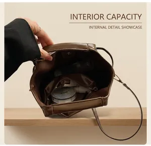 Detail view of large capacity interior with zip pocket in dark brown leather tote bag
