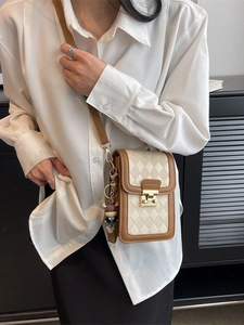Chic quilted crossbody mini phone bag in cream and brown with a cute cow charm detail