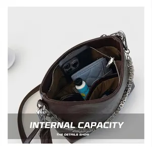 Top view of spacious dark brown leather bucket bag showing phone, wallet and daily items