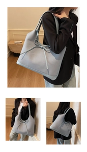 Detail of grey-blue woven texture tote bag featuring an elegant decorative bow knot