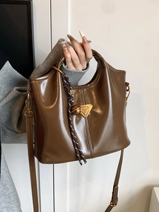 Retro dark brown leather handbag with gold metal logo and woven rope charm detail