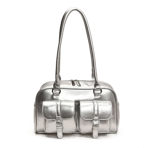 Detail of silver metallic textured shoulder bag featuring dual front buckle pockets