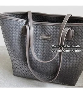 Detailed view of the dark grey woven faux leather tote bag with a metallic logo plate