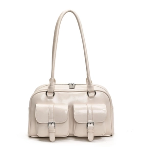 Macro detail of creamy white shoulder bag with two front pockets and silver buckles