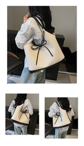Detail of minimalist tote bag with large black bow and contrasting canvas texture