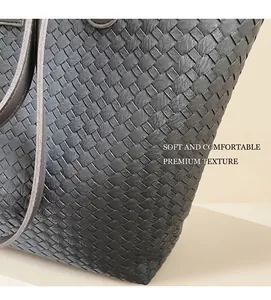 Close-up of black woven leather texture and Intrecciato craftsmanship on the tote bag