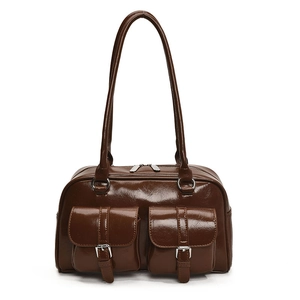 Detail of dark brown glossy leather shoulder bag with silver buckle flap pockets