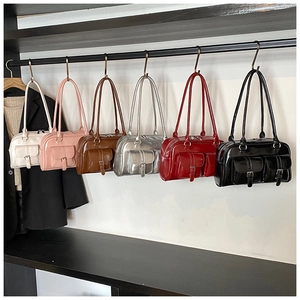 Detailed display of vintage Boston bags in six colors with glossy faux leather finish