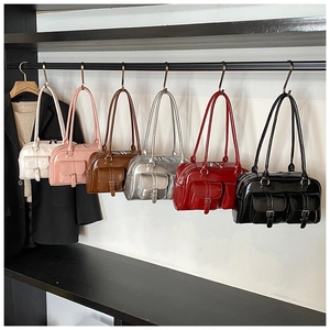 Detailed display of vintage pillow bags in six colors with dual front buckle pockets