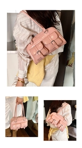 Pink glossy patent leather shoulder bag featuring vintage front buckle pockets and a retro design