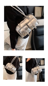 Close-up of silver metallic bowling bag with buckled side pockets and slender straps