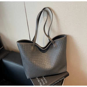 Detailed view of dark grey woven tote bag featuring a ZSKE PARIS branded leather patch