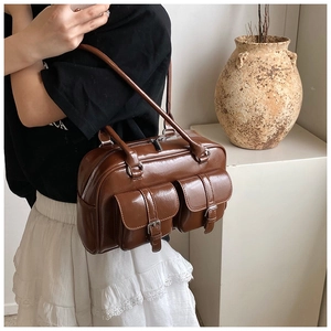 Detail showing high-gloss brown faux leather texture and double front flap pockets