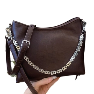 Chocolate brown bucket bag with adjustable strap and silver geometric chain detail
