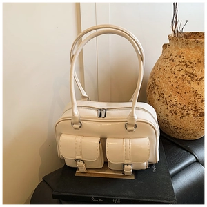 Detailed macro view of cream white high-gloss leather texture and silver buckle pockets