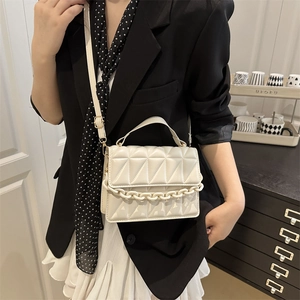 Elegant white quilted crossbody bag with chunky chain strap and long adjustable shoulder belt