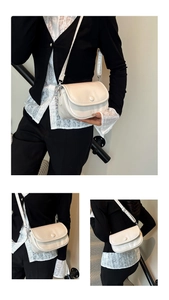 Detail view of cream white minimalist crossbody bag with adjustable silver hardware buckle