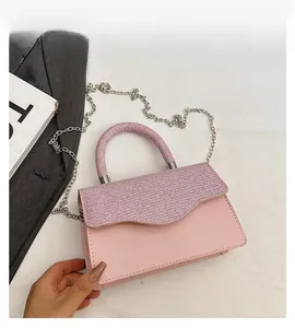 Pink shoulder bag detail with sequined flap, leather base and silver chain strap