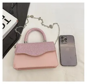Detailed size comparison of pink glitter handbag next to a smartphone and accessories