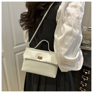 Detail of white embossed letter pattern leather Kelly bag with gold twist lock buckle