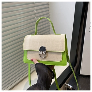 Detail of contrast stitch handbag with lemon green leather and beige woven fabric texture