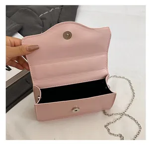 Detail view of the pink mini crossbody bag with silver magnetic closure and inner space
