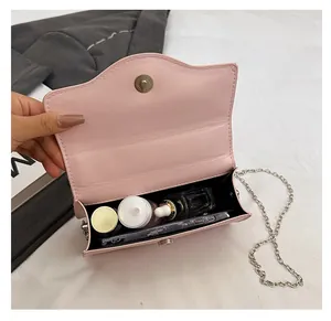 Pink chain shoulder bag with wave-edge flap and interior space for cosmetics