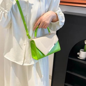 Green leather and beige fabric patchwork handbag with V-shaped flap and metallic trim