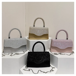 Sparkly rhinestone handbags in silver, gold, pink and black on geometric display stands