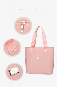 Detail showing smooth zipper puller and reinforced stitching on the pink nylon tote bag