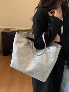 Minimalist silver woven tote bag for women shown as a stylish large capacity shoulder bag