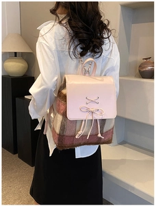 Rosa karierter Rucksack mit Lederschleife und Kettenriemen an weiblichem Modell