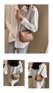 Dettaglio della borsa a sella in ecopelle marrone vintage con logo YUSHAN oro